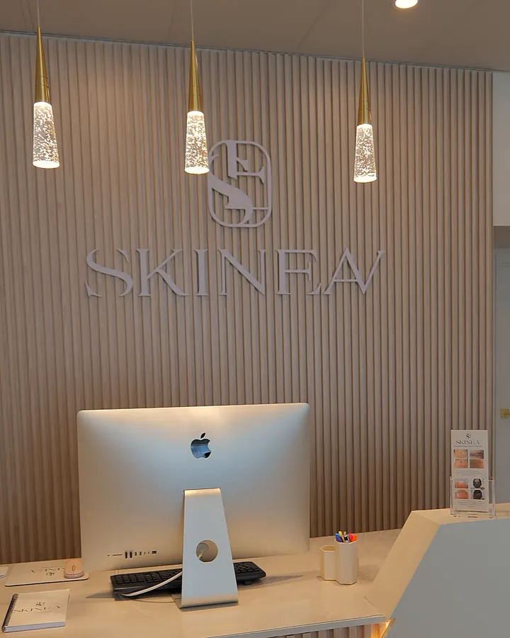 The SKINEAV reception desk and logo wall at the Vaughan clinic